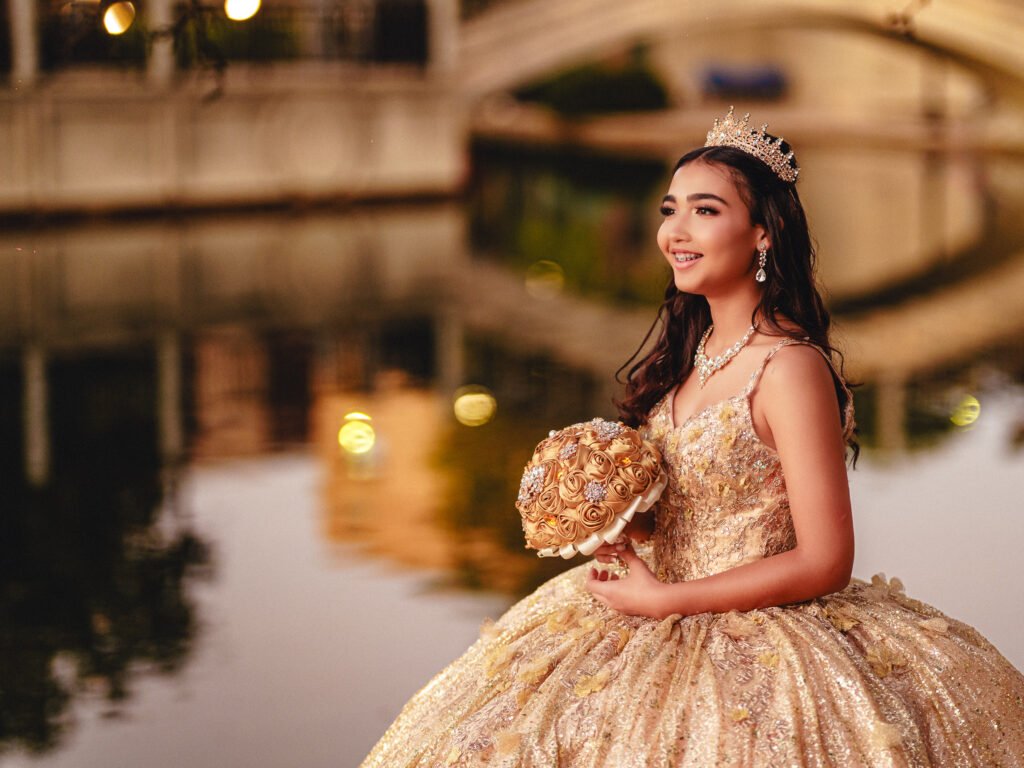Close-up portrait of a quinceañera with a gold bouquet and tiara