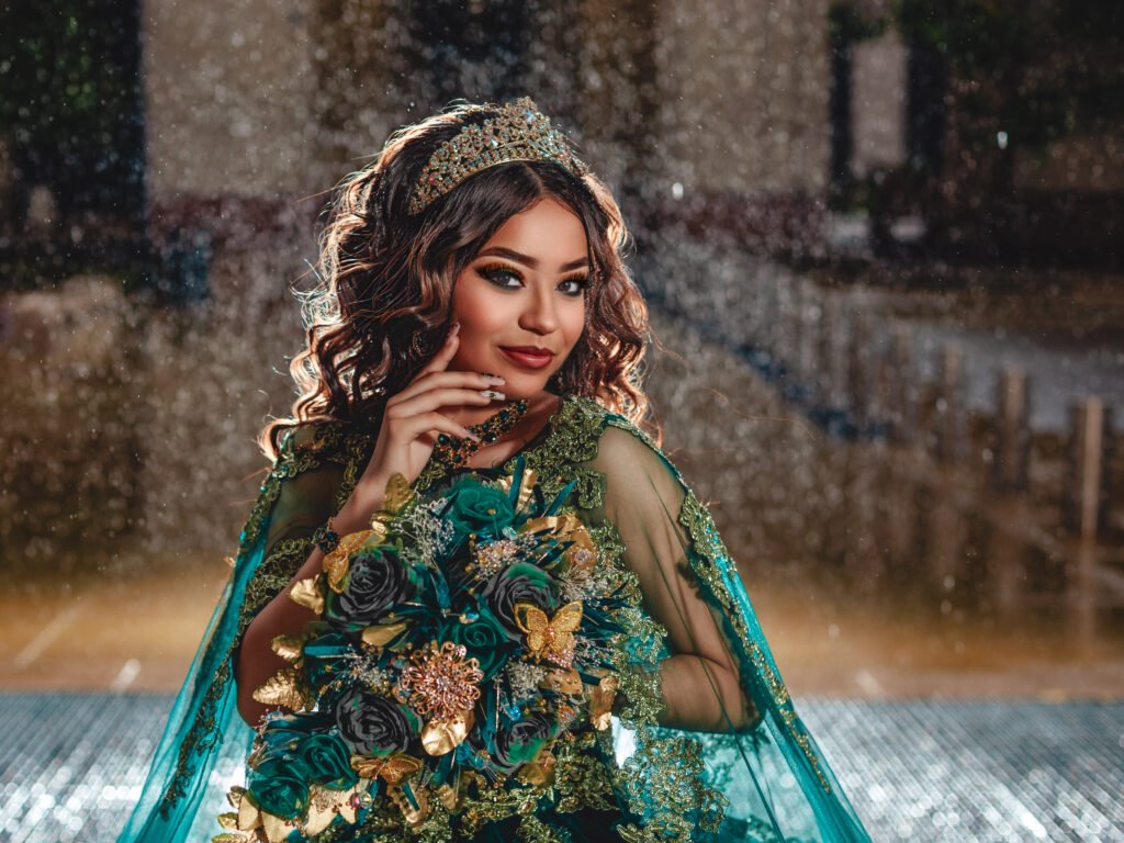 Smiling Quinceanera in emerald gown with moody lighting and fine art aesthetic at Indianapolis Capitol Building.
