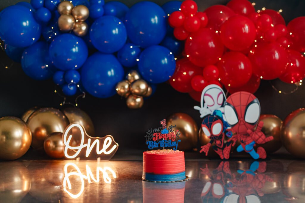 Professional Spider-Man Cake Smash Photography set with red and blue balloons at Gabby Aguirre Fine Art Photo.